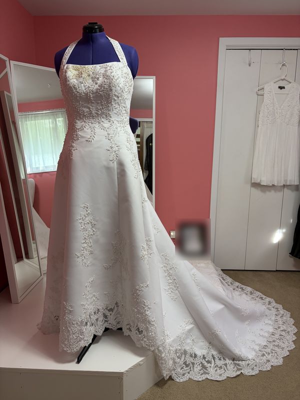 Before: a white wedding gown with lace appliqué and a long train, on a dress form