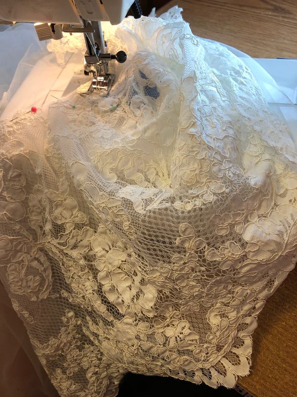 Lace fabric under the presser foot of a sewing machine